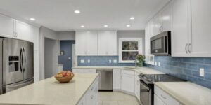 A beautifully remodeled kitchen with white cabinets.