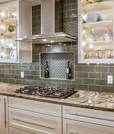 A newly remodeled kitchen with green subway tile and a gas range